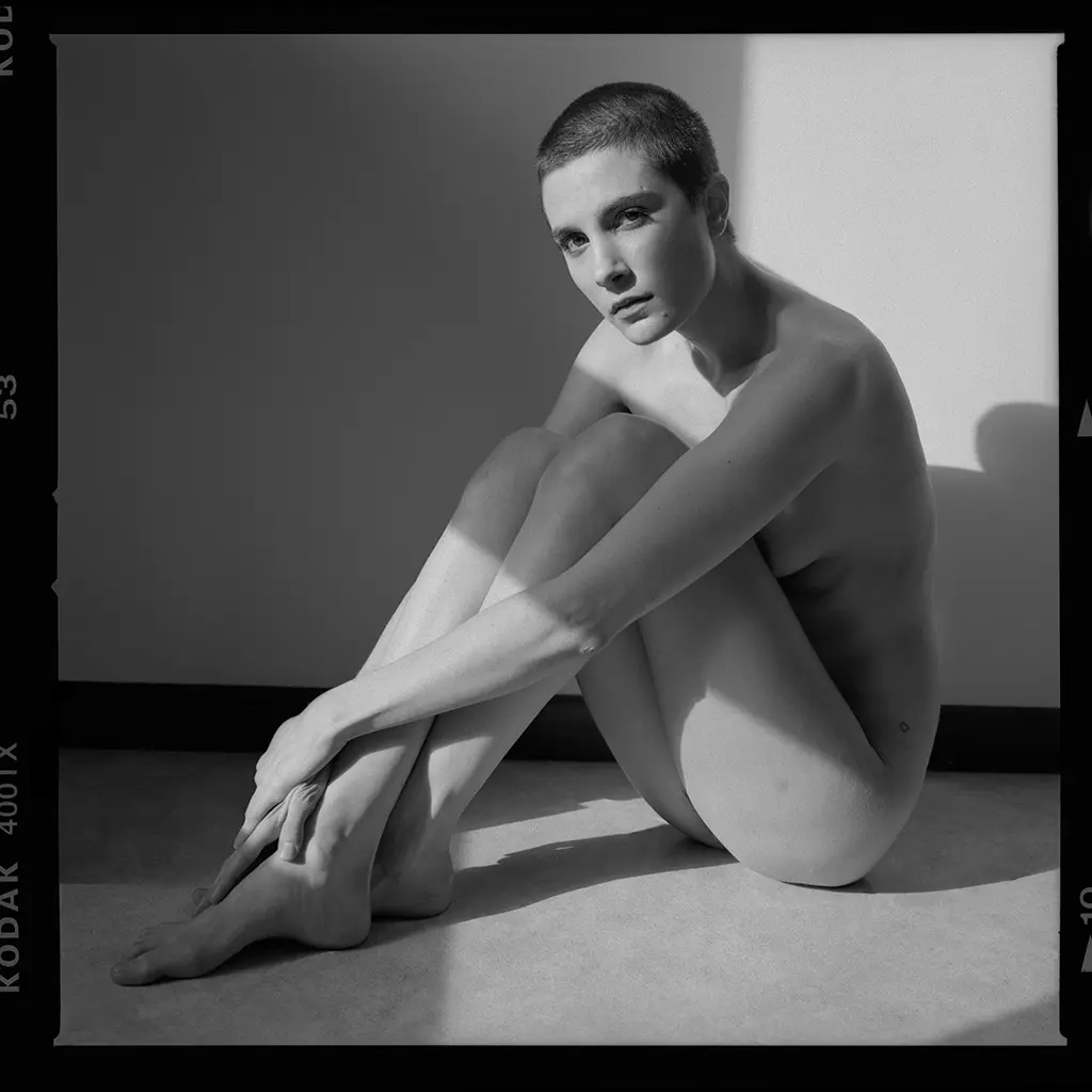A black and white photo of a nude girl